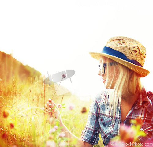 Image of Lens flare, countryside and hipster woman with flowers in field for freedom, wellness and fresh air outdoors. Nature, summer and female person in natural meadow for relax, calm and peace in morning