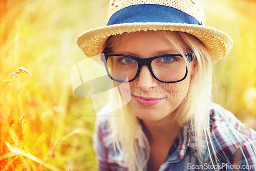 Image of Lens flare, nature and portrait of woman in countryside for freedom, wellness and fresh air outdoors. Hipster, summer and face of female person in meadow field for relaxing, calm and peace in morning