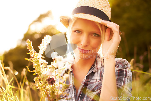 Image of Lens flare, countryside and portrait of woman with flower in field for freedom, wellness and relax outdoors. Nature, summer and hipster female person smile in meadow for sustainability and ecology