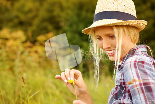 Image of Spring, countryside and woman picking flowers in field for freedom, wellness and fresh air outdoors. Nature, summer and happy hipster female person in meadow for relaxing, sustainability and ecology