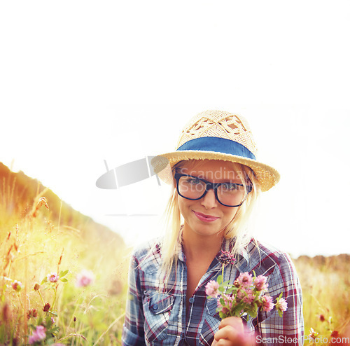 Image of Portrait, countryside and woman with flowers in field for freedom, wellness and fresh air outdoors. Nature, summer and hipster female person in natural meadow for relaxing, calm and peace in morning