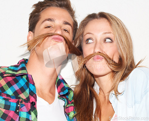 Image of Playful, portrait and couple with hair mustaches being funny, comic and quirky together in a studio. Crazy, young and a man and woman being silly and goofy on a date isolated on a white background