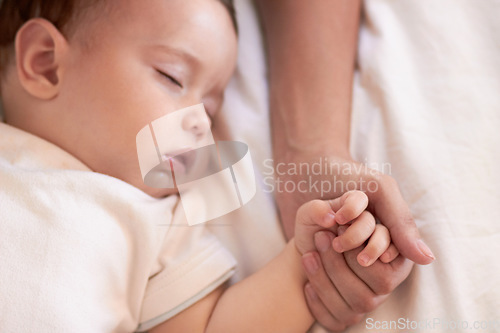 Image of Baby, sleeping and mother holding hands in a home bedroom with parent support, care and love. Relax, bed and young girl with mom in a house tired and sleepy with kid and mama together feeling calm