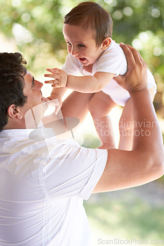 Image of Nature, happy and father playing with baby for care, outdoor games and enjoy fun bonding time together in family park. Child growth, fatherhood and infant with playful dad, papa or man smile for kid