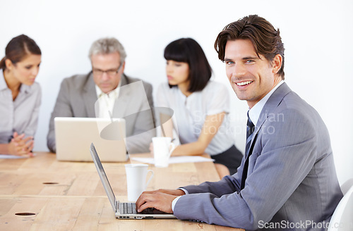 Image of Business man in portrait, typing on laptop in meeting and corporate leader in conference room. Leadership, male person with smile and planning with technology in workplace, confidence and pride