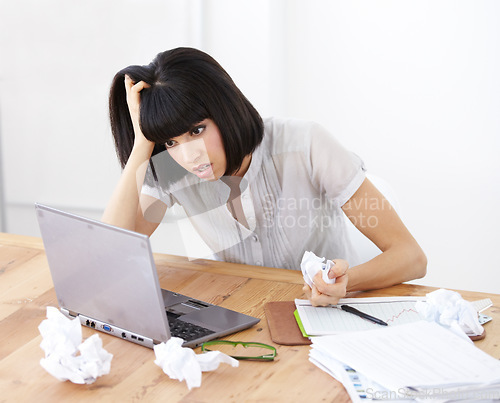 Image of Laptop, paper and frustrated business woman at her desk with burnout, anger and depression or stress. Female entrepreneur with finance paperwork, accounting problem or online 404 error and crisis