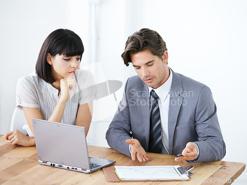 Image of Business people, laptop and meeting for financial report, profit or discussing graph, data or chat at office desk. Businessman or woman in finance strategy, planning or investment review at workplace