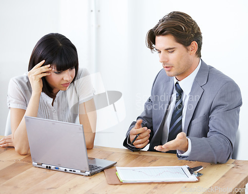 Image of Business people, laptop and problem solving in stress, meeting or financial strategy and report at office. Worry, doubt or confused businessman and woman trying to find solution in corporate finance