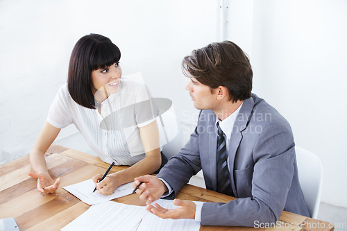 Image of Business people, documents and writing in meeting for strategy, planning or brainstorming on office desk. Businessman and woman in team collaboration with paperwork for project plan at the workplace