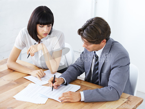 Image of Business people, documents and writing in meeting for planning, marketing or strategy on office desk. Businessman and woman in teamwork collaboration with paperwork for project plan at the workplace