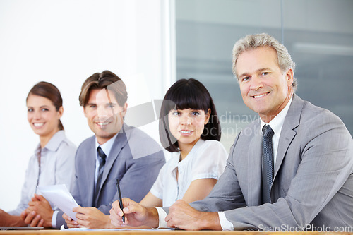 Image of Portrait, teamwork and a group of business people sitting in the boardroom for a planning meeting. Collaboration, strategy or training with corporate men and women working together in the office