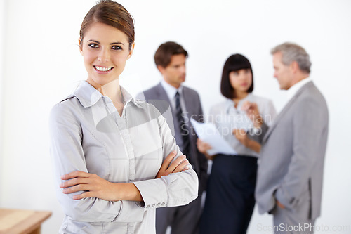 Image of Business woman, portrait smile and arms crossed in meeting for leadership or team management at office. Happy female entrepreneur manager smiling in confidence for teamwork collaboration at workplace