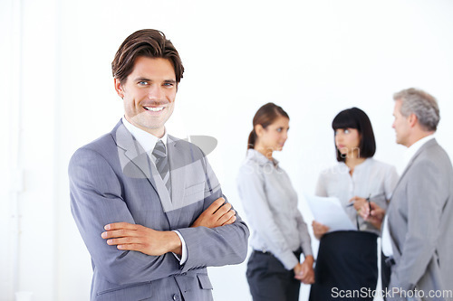 Image of Businessman, portrait smile and arms crossed in meeting for leadership or team management at office. Happy man, boss or manager smiling in confidence for teamwork or collaboration at workplace