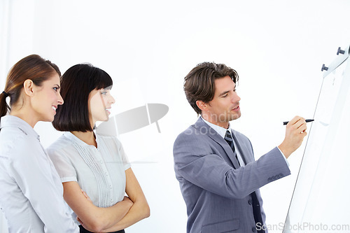 Image of Businessman, writing and coaching in meeting on whiteboard for planning, strategy or collaboration at office. Business people in brainstorming, schedule or training staff in presentation at workplace