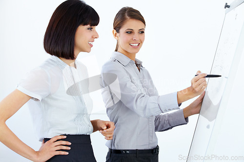 Image of Business people, writing and coaching in meeting on whiteboard for planning, strategy or collaboration at office. Employee women in planning, schedule or training staff in presentation at workplace