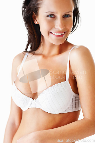 Image of Lingerie, body portrait and underwear of a woman in a bra for beauty, fashion and sensuality on white background. Sexy female model smile in studio for desire, seduction and self love for art deco