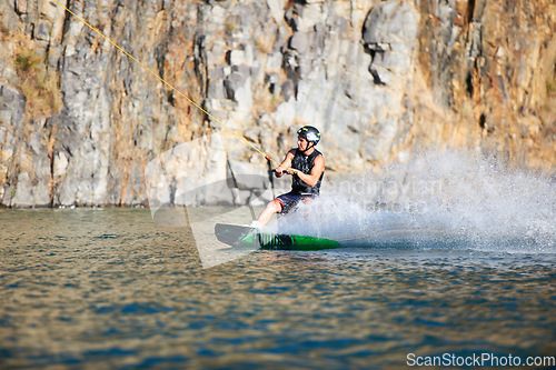 Image of Splash, wakeboarding and water board with man in lake for extreme sports, summer break and travel vacation. Wave, adrenaline junkie and fitness with guy on river for health, adventure and training