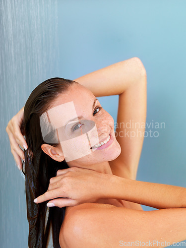 Image of Beauty, smile and portrait of woman in shower for skincare, hygiene and skincare. Wellness, spa and dermatology with face of girl for facial, cleaning and hydration isolated on blue background studio