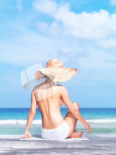 Image of Travel, relax and topless with woman at beach for sunbathing, summer break and freedom in Bali. Sexy, blue sky and tropical with back of girl in bikini on vacation for mockup, peace or beauty on trip