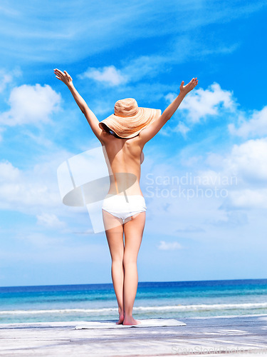 Image of Travel, relax and topless with woman at beach for sunbathing, summer break and freedom in Bali. Sexy, blue sky and tropical with girl in bikini on vacation for confident, peace and beauty on trip