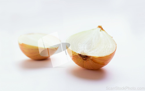 Image of Onion half, vegetable and healthy food in studio for nutritionist food, meal or organic lunch. Cooking, wellness diet and nutrition with cut, chopped or vegan ingredient isolated on white background