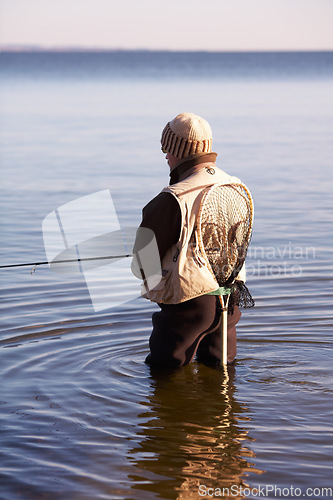 Image of Nature, relax and fishing with man in lake for summer break, hobby and peace on vacation. Sports, casting and rod with fisherman or person standing in fresh water pond or river during a holiday