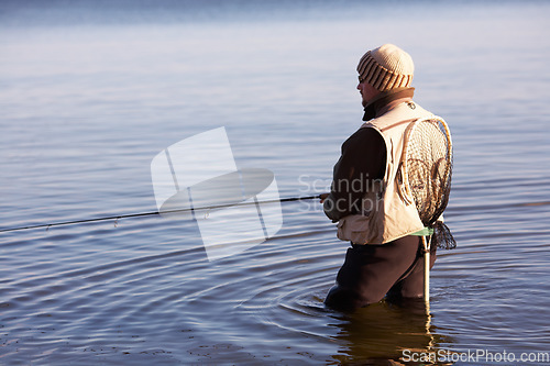 Image of Nature, peace and fishing with man in lake for summer break, hobby and relax on vacation. Sports, casting and gear with fisherman standing in freshwater pond for holiday, recreation and calm