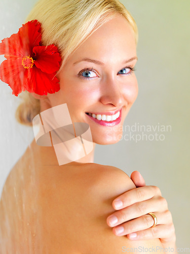 Image of Flower, shower and portrait of woman in bathroom of hotel for cleaning, wellness or hygiene on spa vacation. Tropical, water and washing with girl in villa resort for beauty, skincare or hospitality