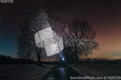 Image of Silhouette of hiker person with flashlight