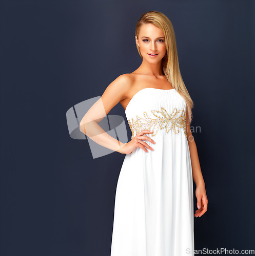 Image of Beautiful woman in a white gala dress and looking gorgeous for prom, orcars or red carpet event. Portrait a fashion and beauty model looking posh in a designer gown with copy space background