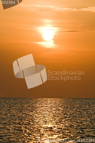 Image of Orange sunset above a quiet serene bay