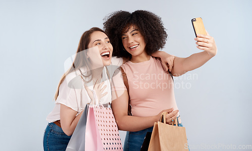 Image of Friends, women with shopping bag and happy in selfie, retail customer and fashion isolated on studio background. Excited female people smile in picture, sale and discount with promotion at boutique