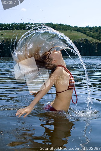 Image of The beauty young woman bathes in the river