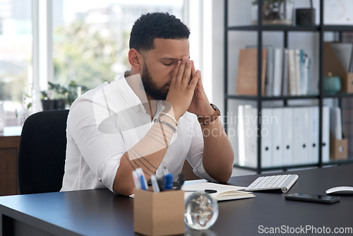 Image of Stress, burnout and tired with a business man at his desk in an office feeling the pressure of a project deadline. Headache, fatigue and frustrated with an exhausted male employee overwhelmed by work