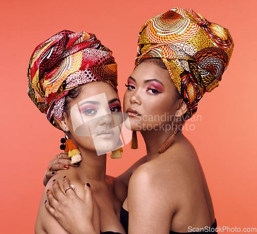 Image of Fashion, beauty and portrait of African women on orange background with cosmetics, makeup and accessories. Glamour, luxury and face of female people hug in exotic jewelry, traditional style and scarf