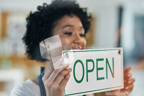 Image of Happy woman, open sign and window at cafe in small business of waitress for morning or ready to serve. Female person or restaurant server holding board for coffee shop, store or cafeteria opening