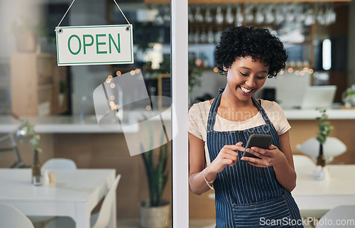 Image of Happy woman, waitress and phone with open sign in communication, social media or online post at cafe. Female person, barista or manager with smile for opening store on smartphone at coffee shop