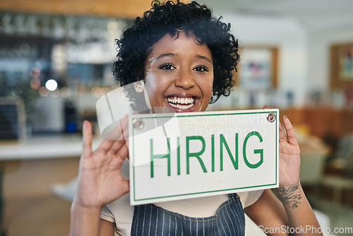 Image of Happy woman, portrait and hiring sign on window at cafe in small business growth, advertising or billboard. Female person or restaurant recruiter holding board for hire or recruiting at coffee shop