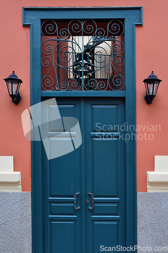Image of blue door with antique iron pattern