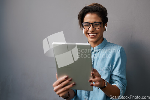 Image of Happy woman, tablet and listening to music isolated on gray background for university e learning, streaming and video. Gen z person or student on digital technology, audio and electronics application