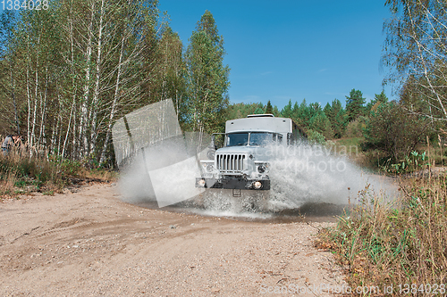 Image of truck passes through a puddle