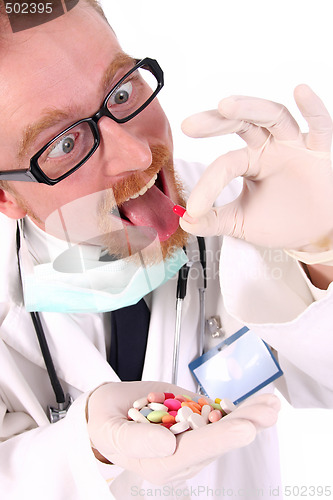 Image of doctor taking hand full of tablets 