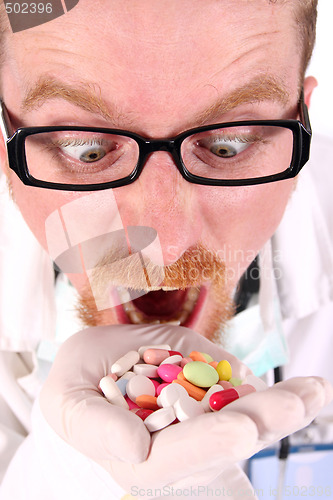 Image of doctor taking hand full of tablets 