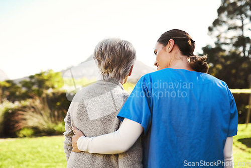 Image of Senior woman, nurse and hug in elderly care, life insurance or support together in nature. Rear view of mature female with caregiver in healthcare, medical aid or garden walk at nursing home outdoors