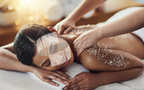 Image of Happy woman, hands and salt scrub in back massage at spa in relax for skincare, exfoliation or body treatment. Calm female smiling in relaxation for therapy, health or zen with masseuse at salon