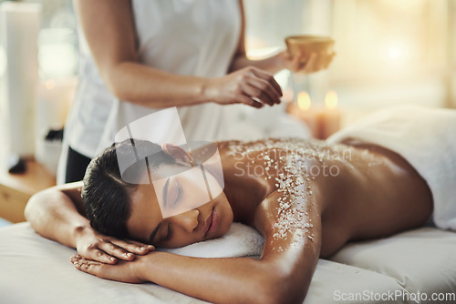 Image of Woman, sleeping and relax in salt scrub massage at spa for skincare, exfoliation or body treatment. Calm female asleep or resting in relaxation for back therapy, health or zen with masseuse at salon