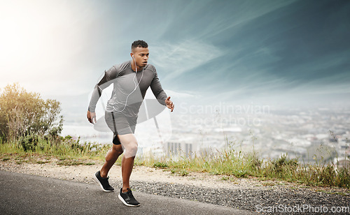 Image of Man, runner and space in street with cityscape for exercise, wellness or music with mockup for health. African male running, listening and audio for focus, workout and outdoor with mock up on road