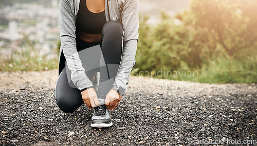 Image of Closeup, exercise and woman outdoor, tie shoes and training with fitness, workout goal and target. Female person, athlete and runner with marathon, practice and sports with wellness, start and health