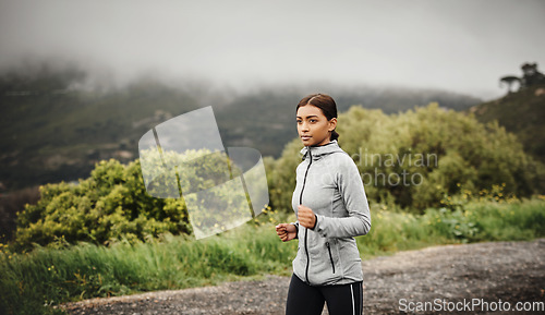 Image of Nature, running and Indian woman training, cardio or workout goal with progress, energy or fitness. Female person, athlete or runner outdoor, mountain view or focus with exercise, sports or wellness