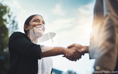 Image of Business people, handshake and meeting in city for partnership, greeting or introduction and welcome outdoors. Happy woman with smile shaking hands for b2b, collaboration or agreement in deal outside
